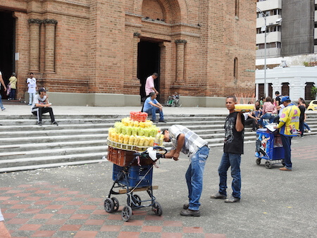 A juice seller outside a church in Medellin